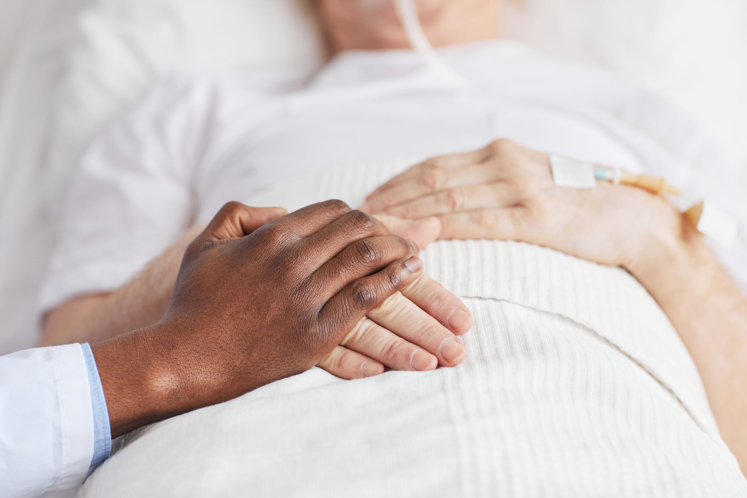 Doctor Holding Hands with Patient in Hospital Close Up